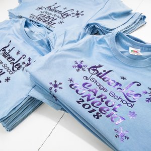 Photo of sky blue t-shirts with metallic purple print for SilverLee Carol Concert