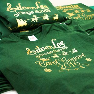 Photo of bottle green t-shirts with metallic gold print for SilverLee Carol Concert
