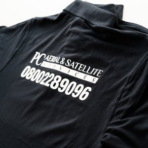 Photo of black polo shirts with PC Aerial & Satellite Services branding