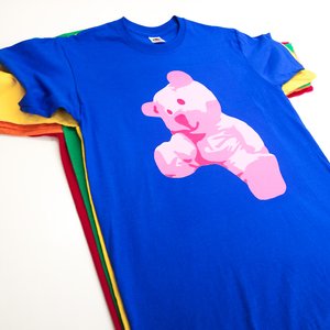 Photo of t-shirts in various colours with artwork by Dounya