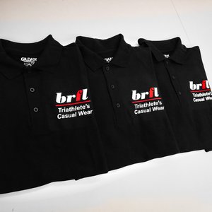 Photo of black polo shirts with Triathletes Casual Wear logo printed on breast
